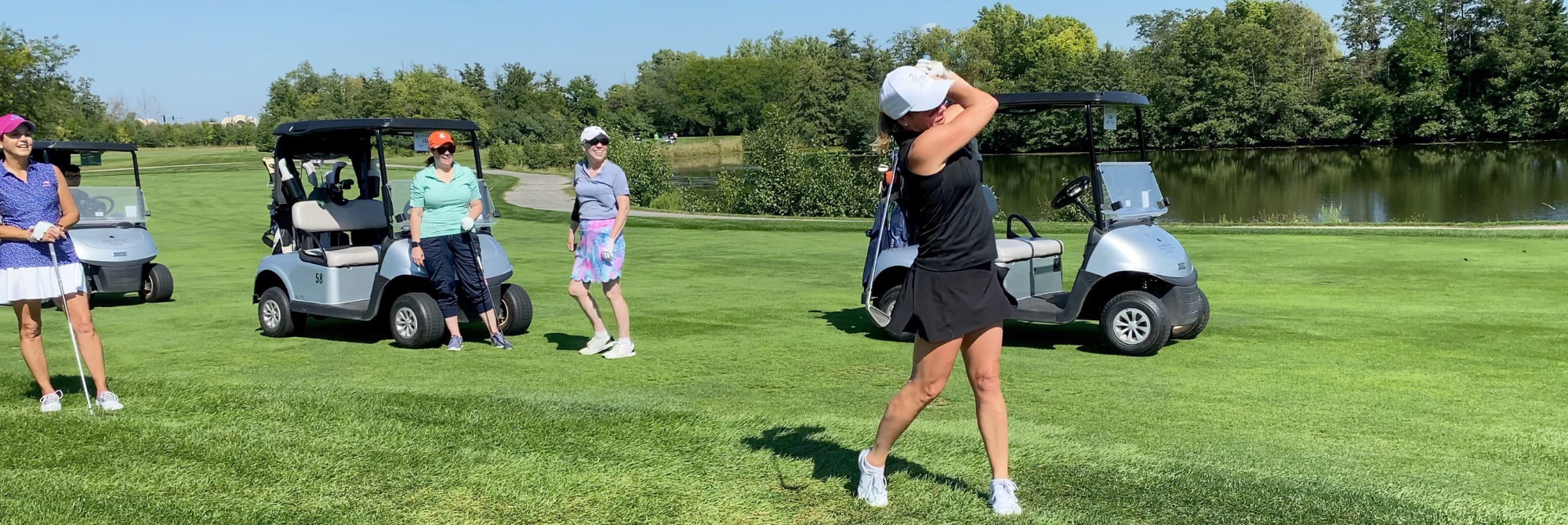 women golfing wide landscape